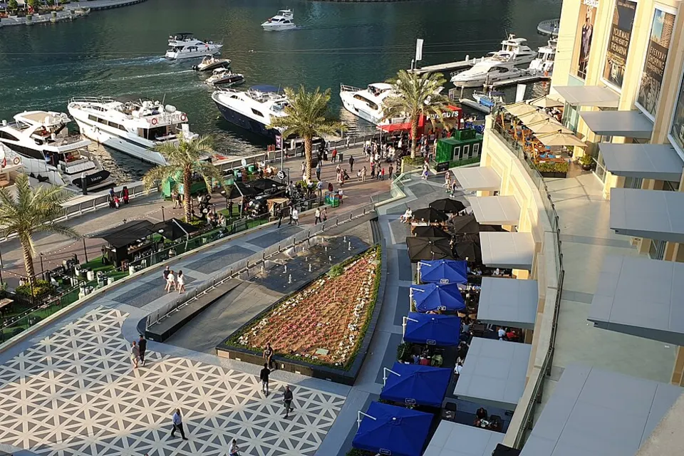 Dubai Marina promenade and water channel with yachts